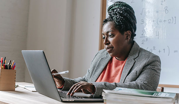 teacher working at laptop